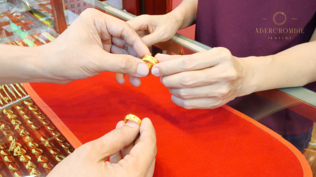 two persons holding gold rings