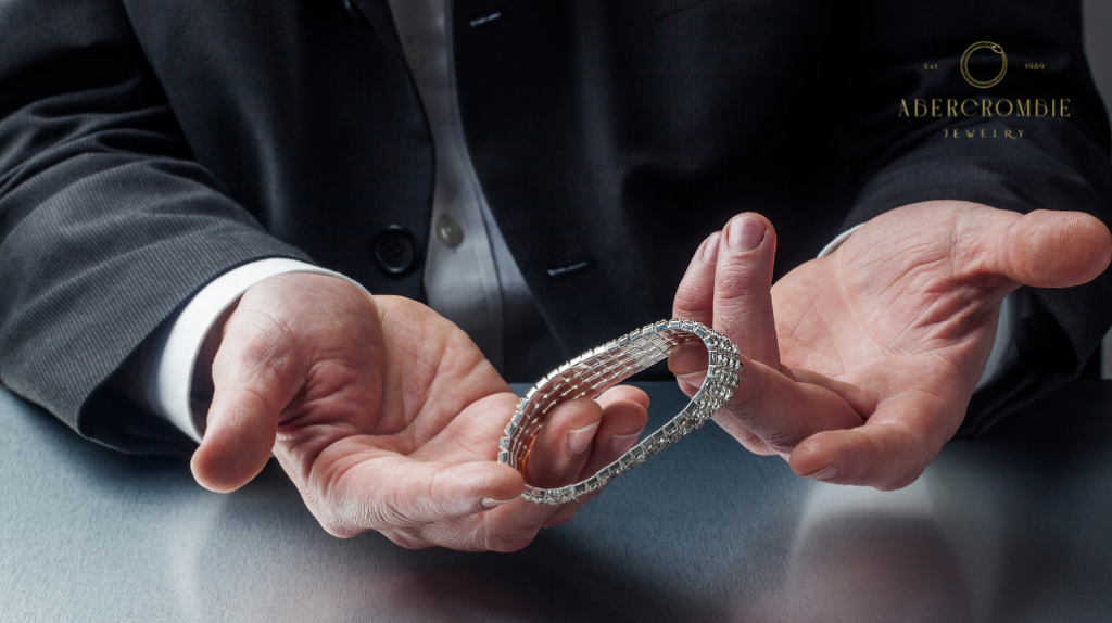 person holding silver plated bracelet