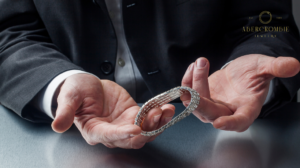 person holding silver plated bracelet