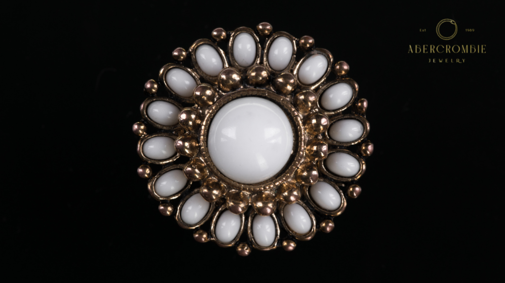 white gemstone studded brooch