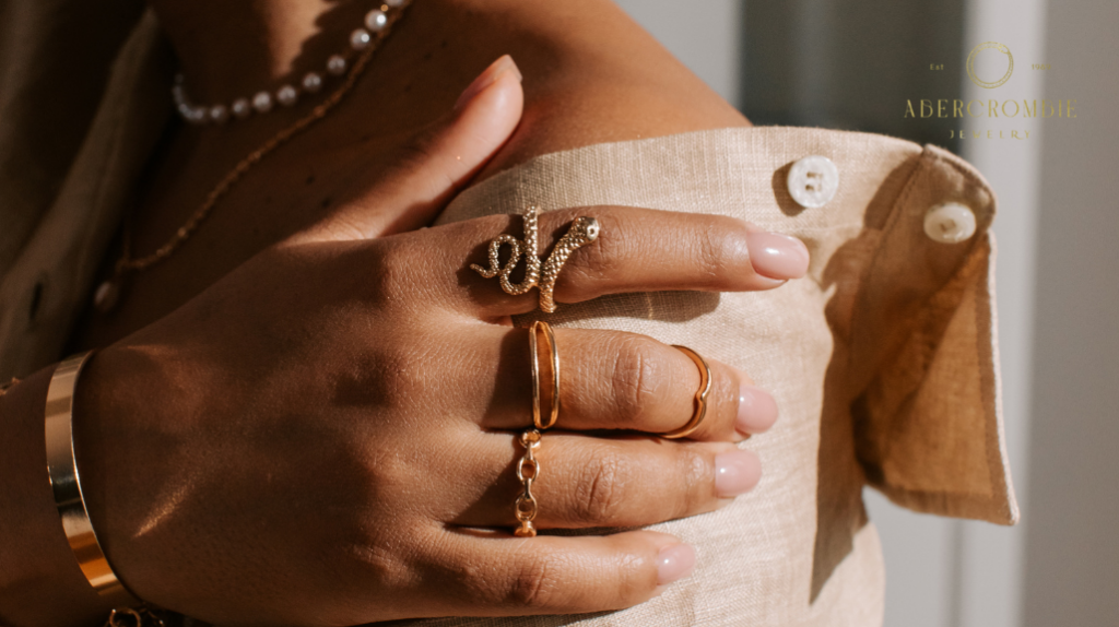 person wearing stackable gold rings and bracelet