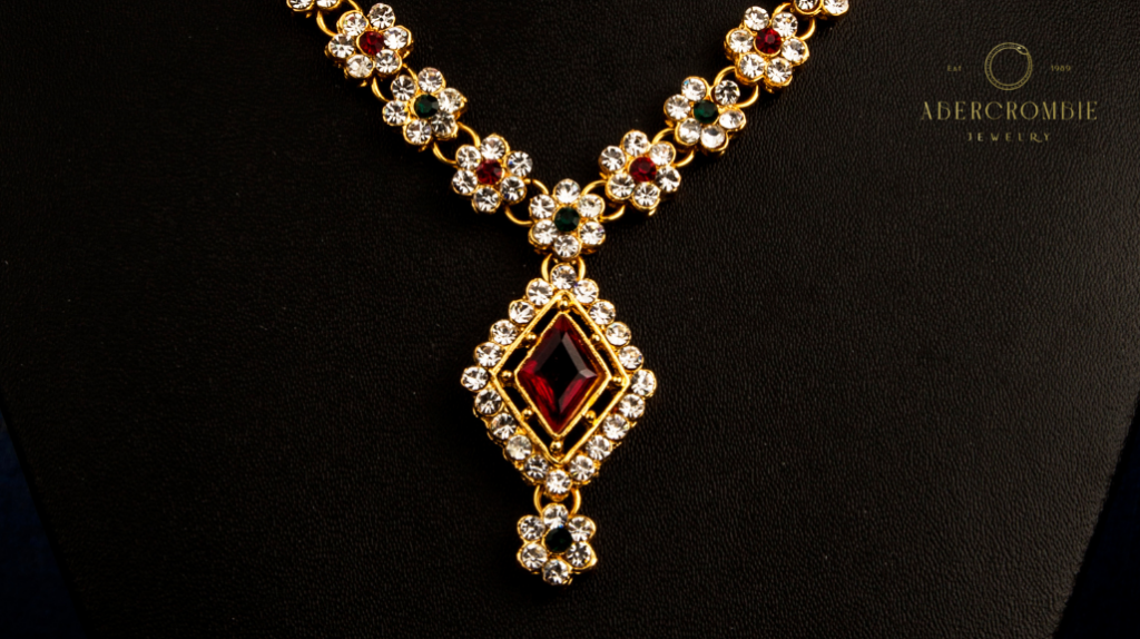 gold necklace with garnet and diamond stones