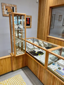 Glass jewelry cases with necklaces and rings at Abercrombie Jewelry