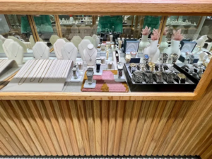 Pre-owned luxury watches and necklaces in a display case at Abercrombie Jewelry